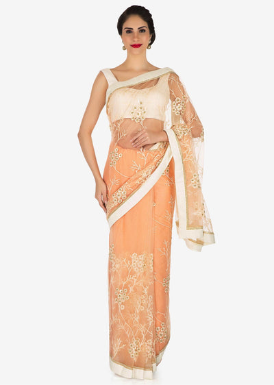 Net saree featured in peach Indian Clothing in Denver, CO, Aurora, CO, Boulder, CO, Fort Collins, CO, Colorado Springs, CO, Parker, CO, Highlands Ranch, CO, Cherry Creek, CO, Centennial, CO, and Longmont, CO. NATIONWIDE SHIPPING USA- India Fashion X